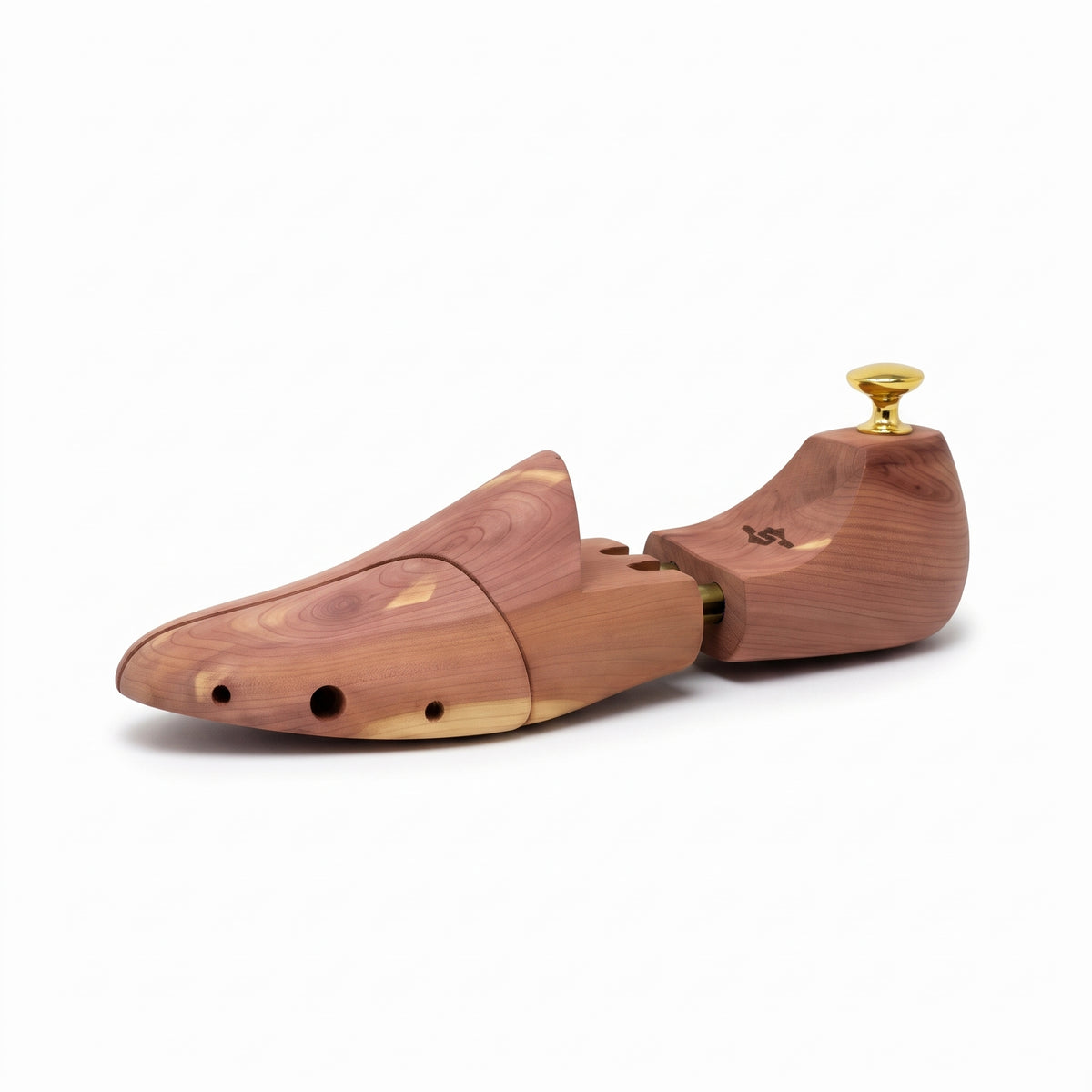 Single aromatic cedar wood shoe tree angled view showing side contour and polished brass knob